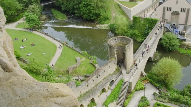 Tourists are enjoying the garden and sunny weather in the Grund, Luxembourg City in Luxembourg, Europe.