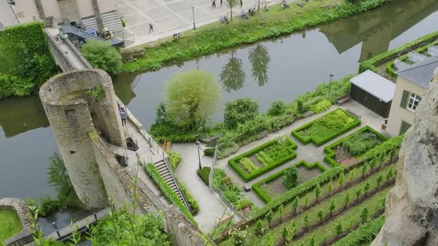 Tourists are enjoying the garden and sunny weather in the Grund, Luxembourg City in Luxembourg, Europe.