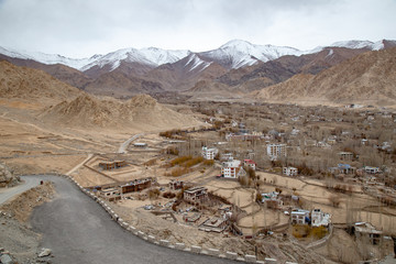 Leh Ladakh city view from Shanti Stupa. Beautiful amazing village in the valley with snow mountain...