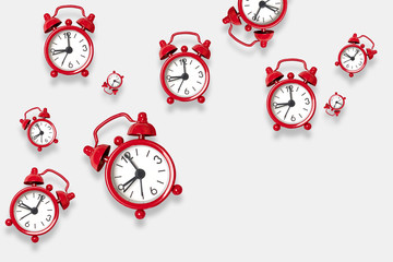 Flat lay red alarm clock pattern on a white background with copy space. You can use it for text for...
