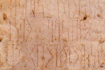 Ancient Kursi inscriptions in Sumhuram Archaeological Park with ruins of ancient town Khor Rori near Salalah, Oman