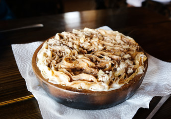Sinori dish of Georgia cuisine, in ketsi. Region Adjara. Cooked with pita that is combined with Georgian cottage cheese and butter.