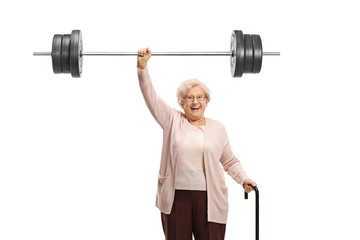 Senior woman with a cane liftiing a barbell - Powered by Adobe