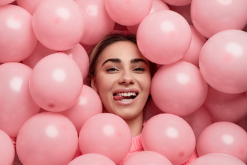 Fototapeta na wymiar Stylish female under pink balloons