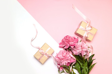 Mothers Day. Festive concept of peonies and gifts on a white and pink background with copy space. You can use it for text for banner, poster, site.