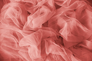 lightweight tulle cloth in living coral colour. Texture background