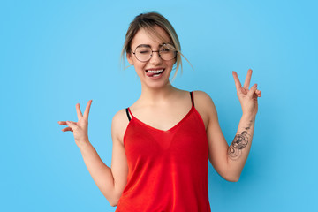 Funny female showing tongue and V sign