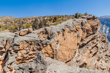 Fototapeta na wymiar Rims of Wadi Ghul canyon in Hajar Mountains, Oman