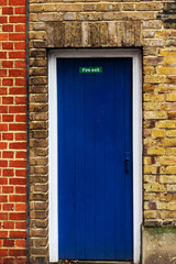 Blue Fire Exit Door in Brick Wall