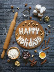Happy holidays food background. Egg, flour and nuts are laid out on a dark wooden table