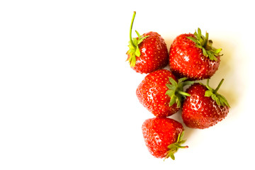 Red strawberries heap on white background view. Selective soft focus. Text copy space.