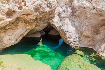 Turquoise water of a creek in Wadi Tiwi valley, Oman
