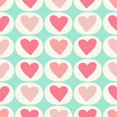 Pink and red hearts in a simple geometric seamless pattern. A vector pattern ideal for valentines fabric, scrap booking and stationery projects.