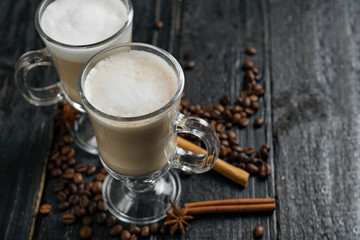 Cappuccino or mocha coffee on a dark wooden table with copyspace