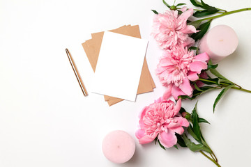 Layout minimalist greeting card with pink peonies flower, envelope for needlework, flowering, flat lay, top view