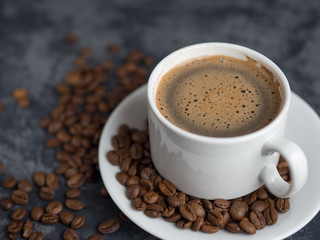 White Cup of espresso coffee with cinnamon on the copyspace concrete table