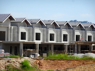 Fototapeta na wymiar Double story luxury terrace house under construction in Malaysia. Designed by an architect with a modern and contemporary style. 