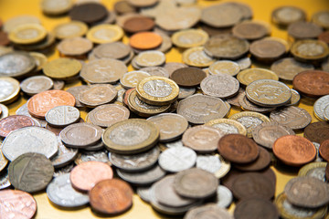 British coins scattered on a gold background