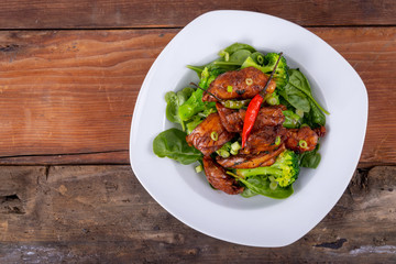 spicy chicken thigh dish over spinach bed