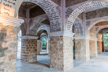 Fototapeta na wymiar MANDALAY, MYANMAR - DECEMBER 3, 2016: Arches with inscriptions in Myatsawnyinaung Ordination hall at Mandalay hill, Myanmar