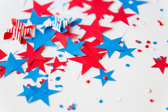 american independence day, celebration and holidays concept - close up of red and blue paper star decorations and confetti on 4th july theme party on white background