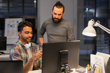 deadline, technology and people concept - creative team s with computers working together late at...