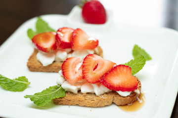 strawberries in slices served with cottage cheese on toasted mini bread