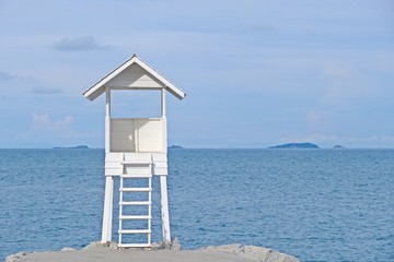 Little wooden white life guard tower at the sea on left of frame,  Khao Laem Ya–Mu Ko Samet National Park, Rayong province, Thailand.