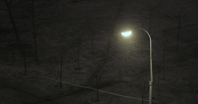 Lantern and sleet at night
