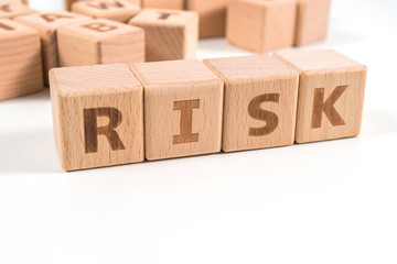 Obraz premium RISK wooden blocks of business concept isolated on white background.