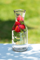 strawberries in jar with mint and water