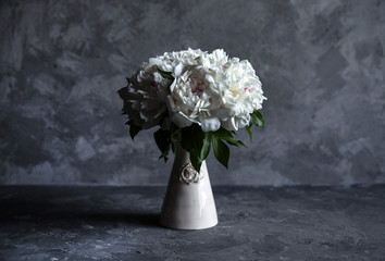 Beautiful peonies on grey concrete background. Wedding, birthday, valentine's day, gift or women's day concept