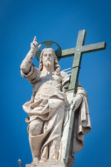 Vatican City - APRIL 17, 2019: Statue of Jesus on the top of Saint Peter Basilica facade ..