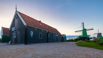 Fototapeta premium Typically traditional Dutch house, windmill, historical architecture and bridge over water at the Zaanse Schans,