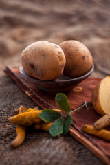 Potato face mask consisting of grated potato and some turmeric powder or haldi in a glass bowl on...