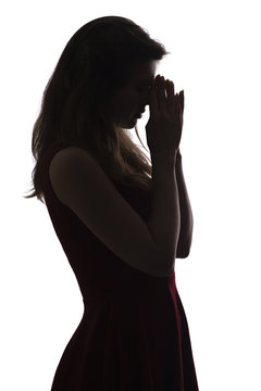 Profile Silhouette Of A Young Woman In Dress Praying, Figure Of Desperate Beautiful Girl On A White Isolated Background, Concept Religion