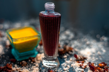 Face mask for skin whitening on wooden surface consisting of besan or gram flour and some rose water. With some dried rose petals and gram flour spread on the surface.