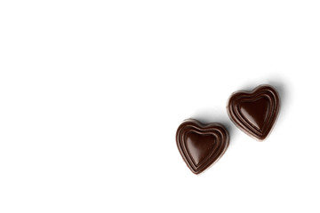 Two chocolate sweets in heart shape isolated on white background.	Top view.