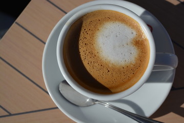 cup of coffee on wooden table in a white cup hot cappuccino 