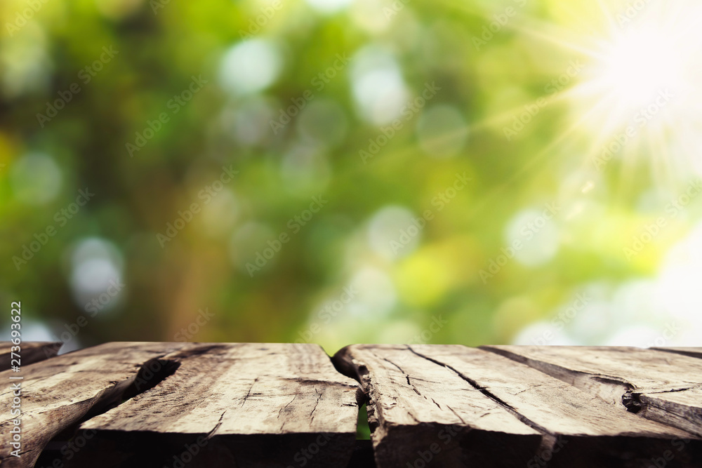Wall mural empty wood with blur tree bokeh and sunshine background