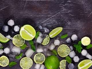 Obraz na płótnie Canvas Fresh lime, mint and ice on dark background.