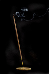 incense burning on black background