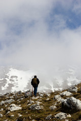 hiker on mountain peak in matese park and fog