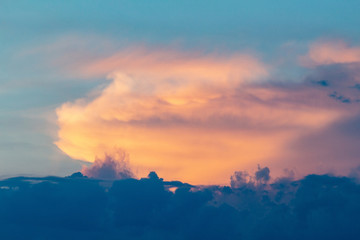 sunset twilight with picturesque orange fiery coral clouds in the rays of the setting sun