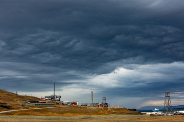 Svalbard landscape nature of the mountains of Spitsbergen Longyearbyen Svalbard building city with church on a polar day with arctic autuum and thunderstorm clouds in the sky