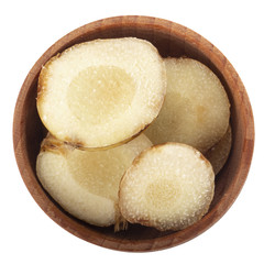 heap of slices of fresh galangal root in wooden cup  isolated on white background. top view