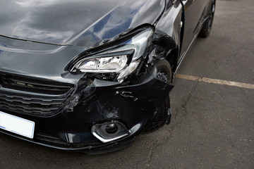 Fototapeta na wymiar Detail Of Damage To Headlight Of Vehicle In Car Park