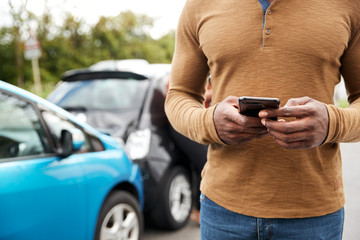 Male Motorist Involved In Car Accident Calling Insurance Company Or Recovery Service