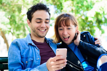 Young couple using application on smartphone