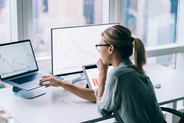 Obraz na płótnie Canvas Focused businesswoman watching graphs on laptop